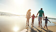 © peopleimages.com - Happy family, walking and holding hands at beach in summer for relax, travel and vacation in Miami. Parents, children and people at ocean with back for trust, holiday and bonding together by sunset