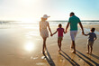 © peopleimages.com - Love, holding hands and family walking at a beach for sunset, travel and bonding in nature together. Support, back and children with parents at sea for adventure, journey or trip in Florida with care