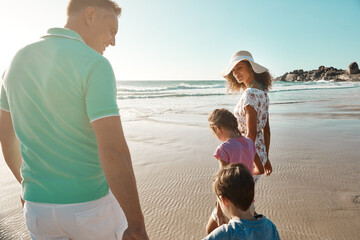 Wall Mural - Love, support and family walking at a beach for sunset, travel and bonding in nature together. Safety, security and children with parents at sea for adventure, journey or trip in Florida with care