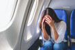 © Farknot Architect - Portrait image of a woman get airsick and headache while traveling on airplane