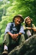 © vefimov - A couple sits on a rock surrounded by trees in a forest, perfect for a romantic getaway or nature-inspired photography