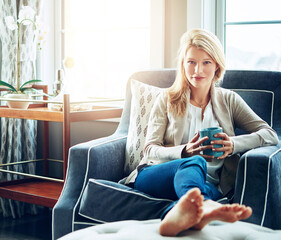 Wall Mural - Portrait, drinking coffee and woman relax in home living room for morning breakfast, latte or espresso for energy. Tea, confidence and girl on sofa for peace, calm and enjoy healthy beverage in house