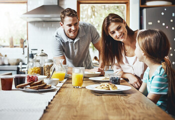 Wall Mural - Family, breakfast and kid with smile in morning for healthy diet, growth and child development. Happy, father and mother with little girl with food on weekend for nutrition, support and care at home