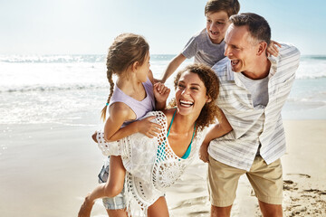 Wall Mural - Happy family, laughing and piggyback at beach in summer for relax, travel and holiday in Miami. Parents, children and people at ocean with back ride for trust, vacation and bonding together by water