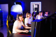 © HENADZY - Team of gamers playing video game on PC at computer club, cyber sport tournament. E-sport championship. 5 players in headset communicate with each other over mic. Multiplayer online competition blurry