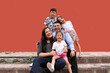 © Arlette - Family of dark-skinned Latino mom, dad, son and daughters looking happy and healthy celebrating their day