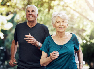 Wall Mural - Running, outdoor and old couple with wellness, exercise and challenge with retirement, healthy and fitness. People in park, senior man or woman with balance, retirement or cardio with sunshine