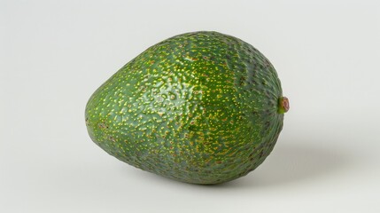Wall Mural - A single green avocado on a white background in a close up shot