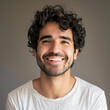 © EeLco - Headshot of a happy Latin man in minimalist clothes