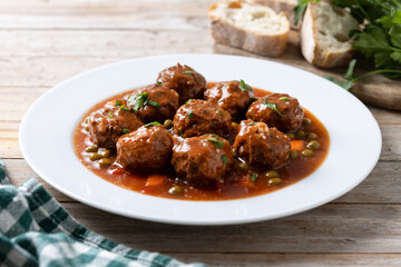 Poster - Meatballs, green peas and carrot with tomato sauce on wooden table