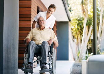 Canvas Print - Elderly, man and caregiver outside with wheelchair, wellness and person with disability for healthcare service. Retirement, nursing home and support or professional nurse, happy and people together