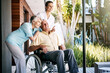 © Reese2000/peopleimages.com - Disability, senior and couple with nurse in outdoor, wheelchair or medical healthcare service at nursing home. Man, woman and caregiver for injury therapy, support or gratitude on retirement wellness