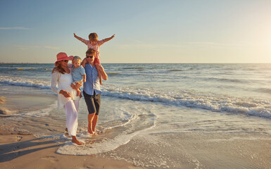 Wall Mural - Happy family, ocean holiday and walking, smile for vacation on tropical island. Man, woman and children together with freedom on beach for travel with wellness, mockup space at sunset in Mauritius