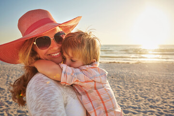 Wall Mural - Happy mother, child and beach with hug in sunset for outdoor holiday, weekend or bonding in nature. Mom, kid and little boy with smile for embrace, love or care in sunshine by ocean coast or sea