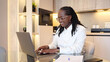 © PeopleVideos - Happy African American female freelancer