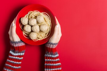 Wall Mural - Comforting homemade spaghetti and meatballs on red background