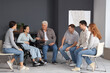 © Pixel-Shot - People with laptop sitting at group therapy session
