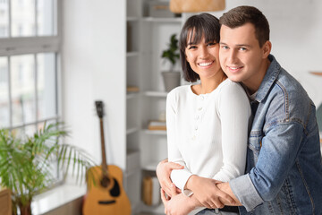 Wall Mural - Young couple in love hugging at home