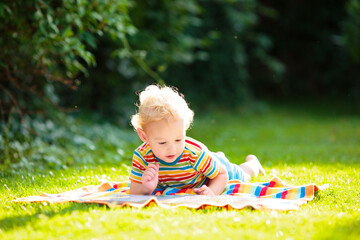 Wall Mural - Kids play outdoor in sunny summer garden