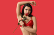 © Pixel-Shot - Beautiful young woman in sexy lingerie with rose flower on red background