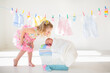 © famveldman - Baby boy on a pile of towels at laundry line