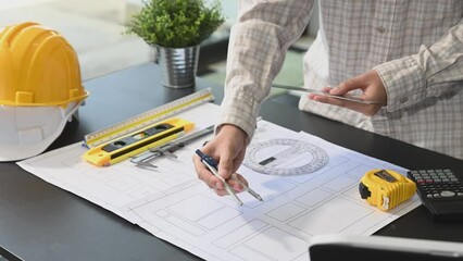 Wall Mural - business man hand working and laptop with on on architectural project at construction site at desk