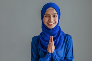 Angry Asian Muslim woman gesturing Eid Mubarak greetings over white background