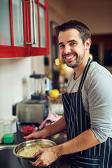 Wall Mural - Portrait, happy man and cooking pasta in a kitchen for health, wellness and food balance at home. Diet, nutrition and face of male person in house for Italian dish, meal prep or cleaning noodles