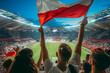 © mediahain.de - Fans waving the flag of Poland at a football match, with the stadium crowd in the background