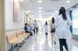 © Ryan - Soft focus on a busy hospital corridor with patients and medical staff in motion