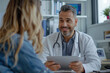 © SnapVault - A doctor with a tablet in his hands smiles as he explains to a patient in his office the results of her medical examination, accurate diagnosis, quality and personalized professional care