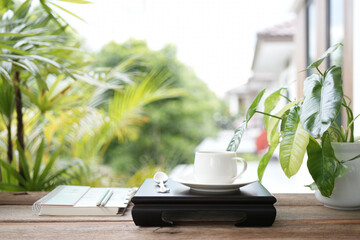 Wall Mural - Vintage teapot and tea cup on black wooden tray on wooden table outdoor