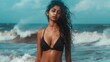 © tantawat - Confident Indian Model in Modern Black Bikini Posing by Ocean Waves
