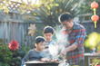 © Jane_S - Father and two sons barbecuing in the backyard.