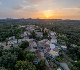 Wall Mural - Aerial drone view of a traditional village in north corfu, summer view with sunset