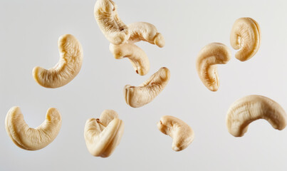 Wall Mural - floating cashew nuts isolated on a clean white background