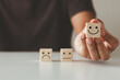 © THAWEERAT - Customer satisfaction concept.  Hand of a businessman chooses a smiling face on a wooden cube block. Customer services best excellent business rating experience.