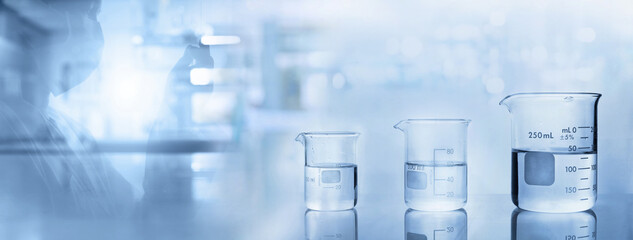 Wall Mural - scientist and beakers with water in chemistry science lab banner background