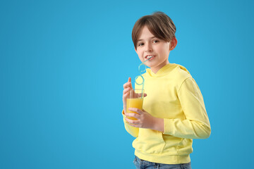 Sticker - Little boy with glass of orange juice on blue background