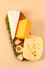Wall Mural - Wooden board with tasty cheese and fig on beige background