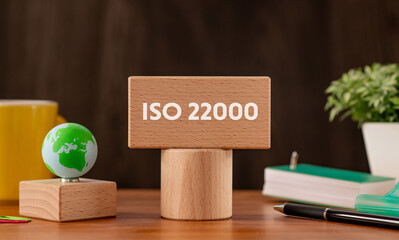 Wall Mural - There is wood block with the word ISO 22000. It is as an eye-catching image.