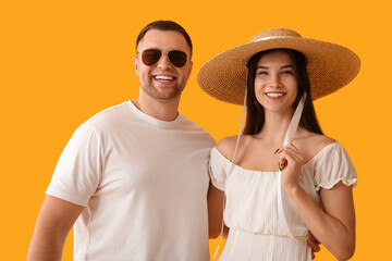 Sticker - Beautiful young happy couple of tourists on yellow background