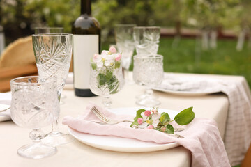 Canvas Print - Stylish table setting with beautiful spring flowers, wine, plates and glasses in garden