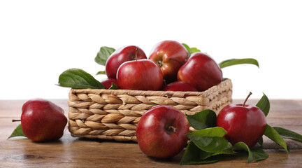 Wall Mural - Fresh red apples and leaves in basket on wooden table against white background