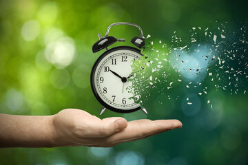 Wall Mural - Time running out. Man with dissolving alarm clock on blurred background, closeup