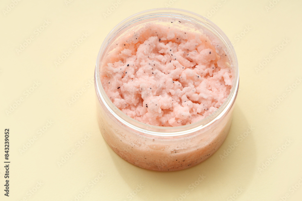 Jar of natural body scrub on color background