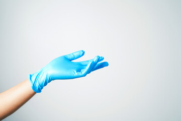 Doctor or nurse hand in sterile gloves in holding position isolated on white