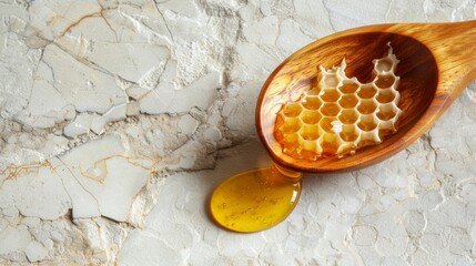 Wall Mural - Honeycomb in a wooden spoon on a marble background for food or health related design