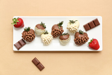 Wall Mural - Plate with chocolate covered strawberries on brown background