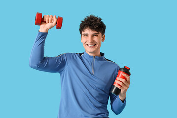 Poster - Sporty young man with protein shake and dumbbell on blue background